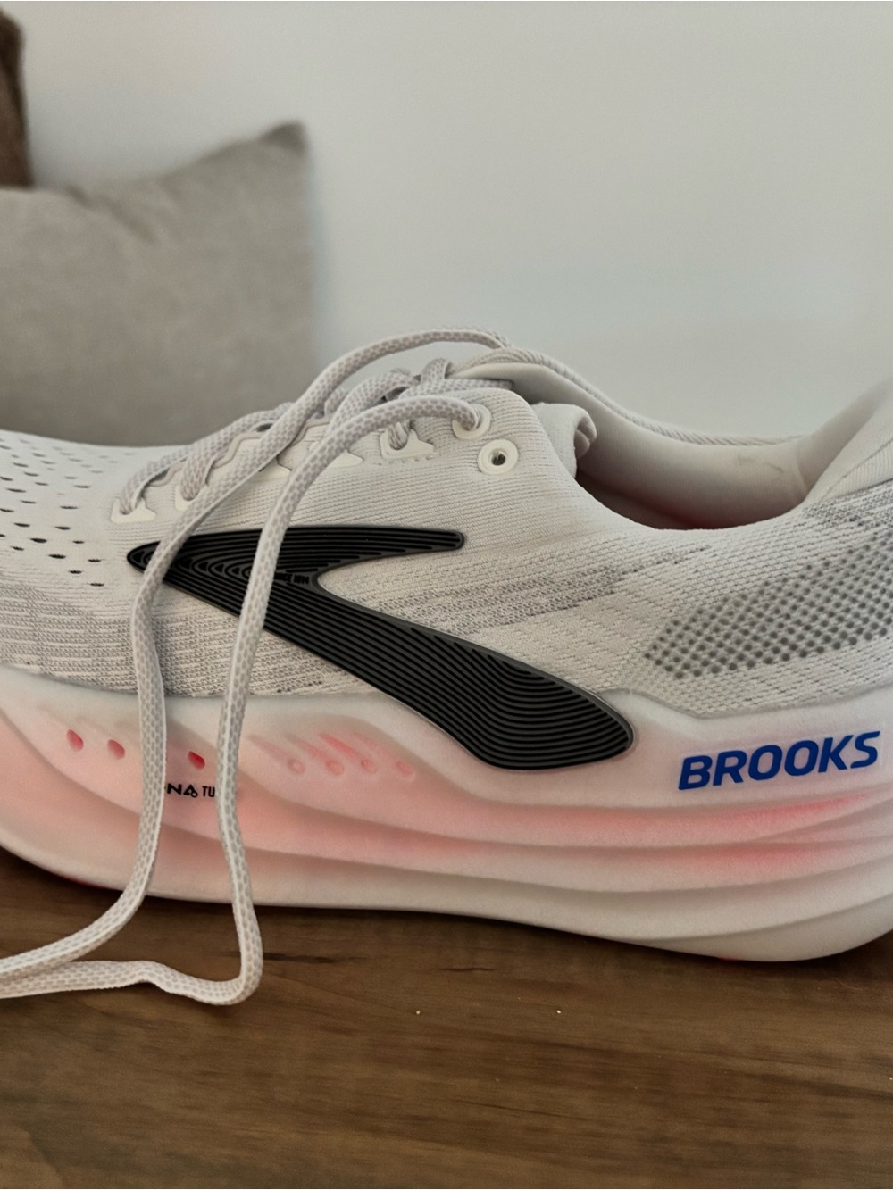 Brooks White Running Shoe with Pink Accent and Black Logo